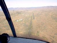  - On approach (with Tim Robel) from the east looking west. The airstrip rises to meet you at about a 2.4% rise or 100' rise in the 2,400' length. More hangar/homes have been built since this photo was taken. - by Terry Irwin