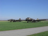  - B-17 The Movie Memphis Belle and C-47 D Day survivor sitting in the grass at Geneseo. - by Terry L. Swann