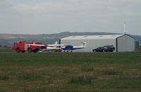  - Pembrey Airport hangar, resident aircraft and Fire and Rescue tender FIRE 2.  - by Roger Winser