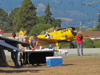  - SNJ-5 N7522U Navy F/Oakland returning to warbird ramp while AFRC 452ndAMW C-17A 05-5139 crew from March AFB sets up recruiting table  @ 2010 Watsonville fly-in - by Steve Nation