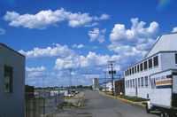  - Looking north along an access road which I believe is now closed to the public. Behind the nearest hangar to the right is the control tower, old airline terminal, MSP FSS, Page (Texaco) hangar and GADO office. - by GatewayN727
