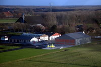  - The airports buildings and platform with medevac helicopter PH-MMT and its friendly pilots. - by Henk van Capelle