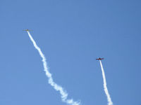  - N779LH and N999ST spectacular smoke formation arrival over SZP's First Sunday Aviation Museum Fly-In prior to tandem landing Rwy 04 - by Doug Robertson