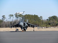  - A Marine Harrier sits on the tarmac of ILM waiting to be refuled as normal air traffic continues around it. - by Mlands87