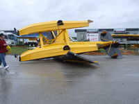  - Husky factory demonstrator came to rest in front of the FAA building after what was rumored to be a tornado rolled through the factory display area at just about noon on Thursday. It's a wonder that no one was killed! Several were taken to the hospital.
 - by Jim Uber