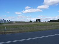  - Kyneton Airfield Hangars and grass strip looking east. - by red750