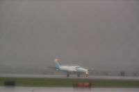  - Alpine Air at Billings Logan in a rain storm. - by Daniel Ihde