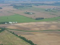  - Ed Fisher's private strip on the west side of Belle Center, Ohio.  The runway begins at the open hanger and goes to the right. - by Bob Simmermon