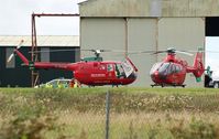  - Two Wales Air Ambulance helicopters at the air ambulance base. - by Roger Winser