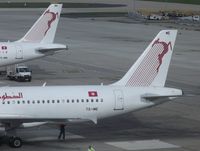  - Tale of two tails. Tunisair A320 TS-IME had just docked to gate as TU 722 from Tunis. Sister-ship Mike-November was being serviced in anticipation of her return to Djerba - by Alain Durand