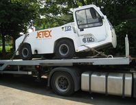  - Still strapped on the delivery flatbed trailer, and looking not in a hurry to hit the aprons and start a collection of dents ! - by Alain Durand