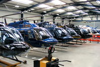  - lineup of Bell 206 Jetrangers in the Tiger Helicopter's hangar at Shobdon. From L to R, G-OMDR, G-BYBI, G-XBOX, G-ONTV, G-SPEY, G-DOFY, G-BSBW.  - by Chris Hall
