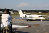  - From the spotting location at PDK, a person photographs a nice Hawker 4000, N40VK as it taxis by for departure. - by Dean Heald