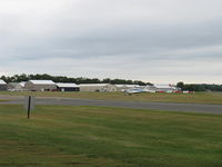  - Aircraft hangars, windsock, taxiway in foreground - by Doug Robertson