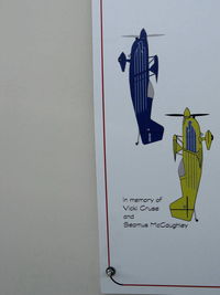  - Airport Arrival and Departure Requirements, posters dedicated to the late Vicki Cruse and Seamus Mccaughley aerobatic stars. At Self-Fuel Dock, Airport Center. - by Doug Robertson