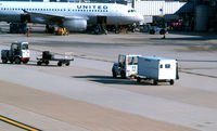  - Tug #65 with baggage cart on the ramp - by Ronald Barker