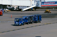  - Tug with # 18150 baggage carts on the ramp - by Ronald Barker