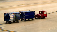  - Tug 59045 with two baggage carts - by Ronald Barker