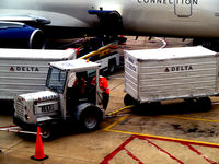  - Tug 40 with baggage cart in a congested Delta ramp - by Ronald Barker