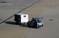  - Tug # 136 with baggage cart - by Ronald Barker