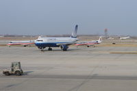  - United Airlines Airbus A320 taxiing in on A4 with two American Eagle Embraer jets in the penalty box and a United Express  Embraer departing 32L in the background. - by Mark Kalfas