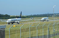  - Ryanair B737-800's EI-DWC & EI-DAO Taxiing to runway 06,while in the back ground is G-RJXI Midland 66 landing  - by Mike stanners