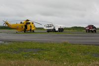  - RAF SAR Sea King taking on fuel with Fire and Rescue tender (FIRE 2) in attendence. - by Roger Winser