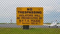  - A sign reading No Trespassing violators will be prosecuted by N.F.T.A Police. Section 1151-4 - by aeroplanepics0112