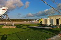  @ Treasure Cay Airport - A peek at the airfield through the fence - by Murat Tanyel