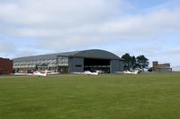  - Overview of the Air Cadets flightline. The old 1939 built J-type hangar is still in use, but the watchtower to the right is now replaced by a mobile caravan. - by Joop de Groot