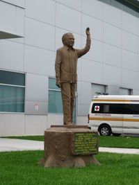  @ Daniel Oduber International Airport - Daniel Oduber Statue in between the New and Old Liberia Costa Rica Terminal Buildings  - by Mark Silvestri