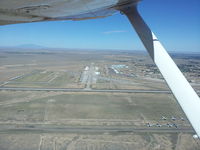  - From a point 2 miles SE of the Roswell International Air Air Center Airport at approximately 1,000' AGL looking northwest, about 125 aircraft are visible on the tarmac. - by Richard Warner