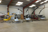  - from L to R, G-BLME, G-MISK, G-MENU, G-JTSA and G-OJRH inside the Heli Air hangar - by Chris Hall