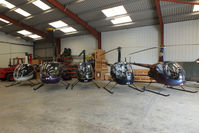  - from L to R G-JHEW, G-RUZZ, G-OSAZ, G-BMIZ and G-ZAPY inside the Heli Air hangar - by Chris Hall