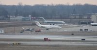  - Across the ramp - Little Caesars Gulfstream II, former Detroit Pistons DC-9s, an O-2 that doesn't look flyable and a Cessna 172 - oh yeah and behind that The Playhouse Nudie Bar - by Florida Metal