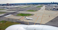  - We are just coming in over the northern end of Newark Airport, about to land on Runway 22L.  To the right is the northern freight terminal, used by Kalitta Air and DHL; to the left is Terminal C.  The shorter cross-runway, Runway 29 is in the middle.  A U - by Daniel L. Berek