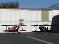  - N49BR Christen EAGLE Experimental class and N189PT Aerotek PITTS S-2A Production class aerobatic biplanes share a hangar - by Doug Robertson