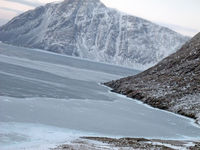  @ Grise Fiord Airport - In the turn to a heading of 187 True. Notice how close the mountainous terrain is. - by Tim Kalushka