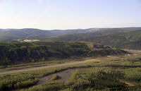  - On a left hand downwind for runway 02 at Dawson City. - by Tim Kalushka