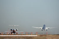  - American Airlines 777 lifts off from runway 36R while American Eagle sits  - by Zane Adams