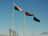 - Flags at the entrance to Swansea Airport. November 2012. - by Roger Winser