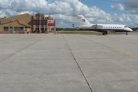  @ Venice Municipal Airport - The FBO facility, Suncoast Cafe (excellent) and Tommy Hilfiger's jet on the ramp at Venice, FL - by Bob Simmermon