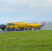  - a fuel bowser arrives to refuel the red arrows while in the back ground 3 Patrouille de france Alphajets can be seen taking off from runway 09 - by Mike stanners