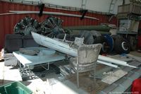  @ Shell Creek Airpark Airport - Various Douglas DC-3 parts in the open hangar. - by Carl Byrne (Mervbhx)
