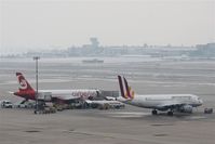  - View from terminal building over apron and rwy 07/25 to tower, which is constructed out of airport area... - by Holger Zengler