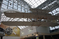  - It is very fitting that Dayton International Airport would have this Wright Flyer replica in the main terminal area, with a mural of the Wright Brothers as a backdrop. - by Daniel L. Berek