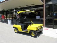  - The airport has many forms of personal ground transport. Here is an electric vehicle that can cleverly seat four, with two perhaps in the shade. - by Doug Robertson