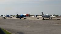 - Resident aircraft on the general aviation apron. - by Roger Winser