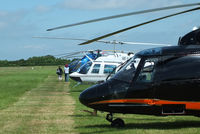  - line up of helicopters being used for ferrying race fans to the British F1 Grand Prix at Silverstone - by Chris Hall
