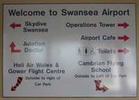  - Sign showing some of the operators based at Swansea Airport. - by Roger Winser